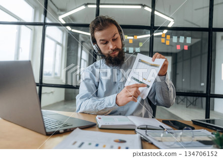 Online meeting, showing document, plan. Businessman is working in the office Online meeting, showing document, plan. Businessman is working in the office 134706152