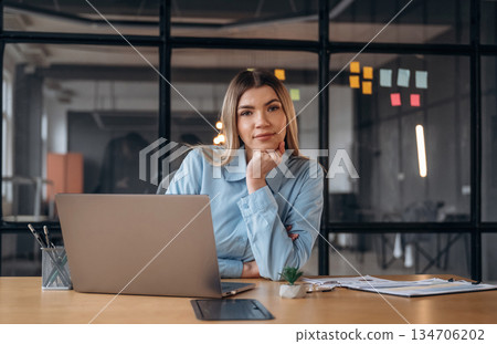 Woman is in the modern office, formal wear Woman is in the modern office, formal wear 134706202