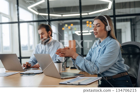 Working by laptops. Man and woman are in the office together 134706215