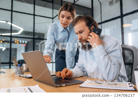 Man and woman are in the office together Man and woman are in the office together 134706237