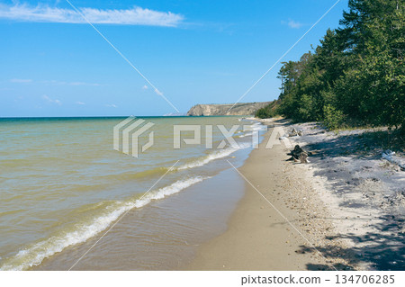 Sandy beach along ocean shore with calm wave. Nature landscape Sandy beach along ocean shore with calm wave. Nature landscape 134706285