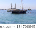 Traditional wooden boat anchored in the calm waters of the Aegean Sea 134706645