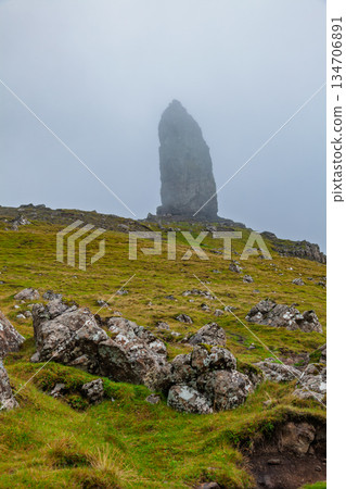 Old Man of Storr rising from misty hillside Isle of Skye Scotland Old Man of Storr rising from misty hillside Isle of Skye Scotland 134706891