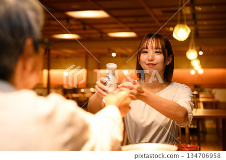 A woman pours sake A woman pours sake 134706958