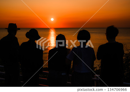 People watching the sunset at the beach 134706966