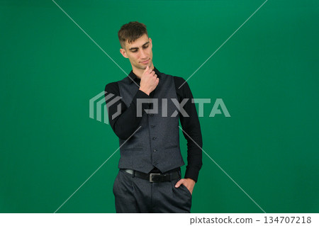young handsome man feeling thoughtful, wondering or imagining ideas, daydreaming and looking up to copy space 134707218