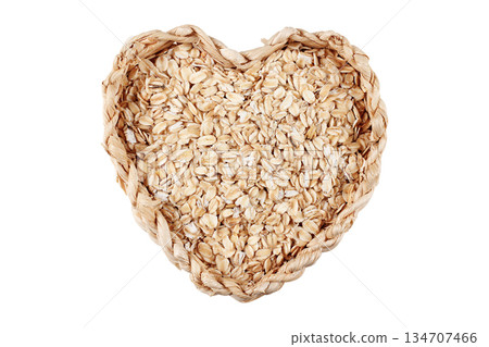 Organic oat flakes in a rustic basket isolated on a white background with space for text. Packaging photograph Organic oat flakes in a rustic basket isolated on a white background with space for text. Packaging photograph 134707466