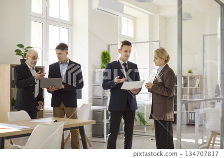 Business team discussing analytics in office, managers planning strategy together 134707817