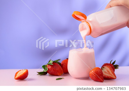Strawberry milkshake smoothie and fresh berries on a colorful background. Strawberry milkshake smoothie and fresh berries on a colorful background. 134707983
