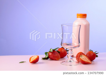 Strawberry milkshake smoothie and fresh berries on a colorful background. Strawberry milkshake smoothie and fresh berries on a colorful background. 134707990
