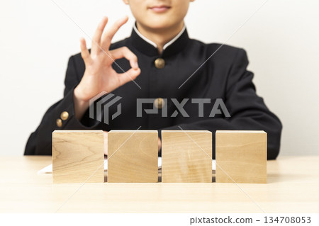 A male student making an OK sign with a blank block A male student making an OK sign with a blank block 134708053