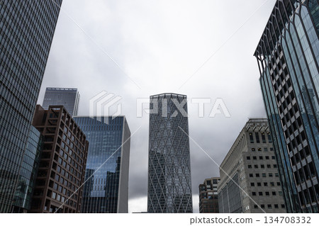 Low Angle View of Modern Skyscrapers in Cloudy City 134708332
