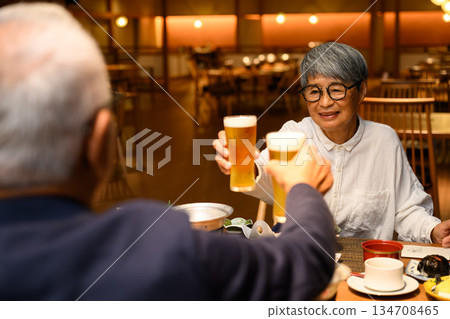 Elderly couple toasting with beer 134708465