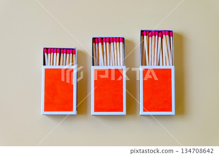 Pile of Wooden unused match stick in red box over the color background. 134708642