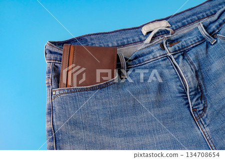 A brown pocket money in blue jeans pocket. Finances. A brown pocket money in blue jeans pocket. Finances. 134708654