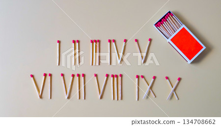 Pile of Wooden unused match stick in Roman numerals. 134708662