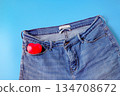 Red heart in blue jeans pocket, concept of romance. 134708672