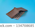 A brown leather wallet on color background. 134708685