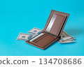 A brown leather wallet on color background. 134708686