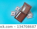 A brown leather wallet on color background. 134708687
