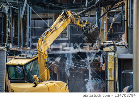 Building demolition work using heavy machinery 134708794