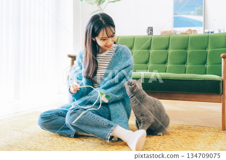 Woman playing with a cat 134709075