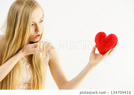Young woman in love blowing kisses to heart Young woman in love blowing kisses to heart 134709418