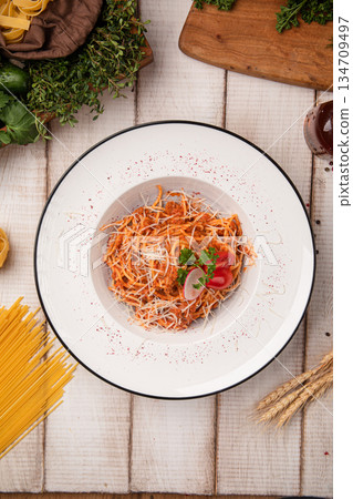 Spicy tomato pasta with grated cheese 134709497