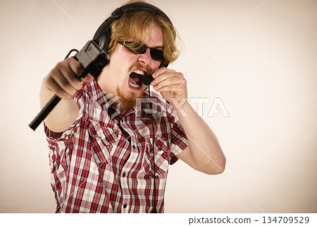 Gamer man shooting from gun Gamer man shooting from gun 134709529