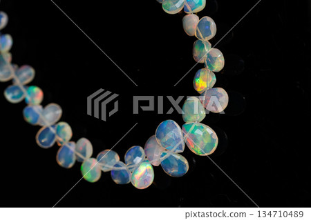 Ethiopian Opal Drop Cut Play of Color Natural Stone Black Background Material Ethiopian Opal Drop Cut Play of Color Natural Stone Black Background Material 134710489