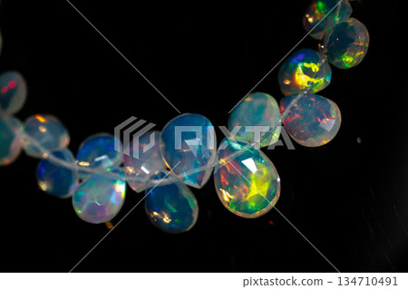 Ethiopian Opal Drop Cut Play of Color Natural Stone Black Background Material Ethiopian Opal Drop Cut Play of Color Natural Stone Black Background Material 134710491