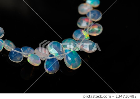 Ethiopian Opal Drop Cut Play of Color Natural Stone Black Background Material Ethiopian Opal Drop Cut Play of Color Natural Stone Black Background Material 134710492