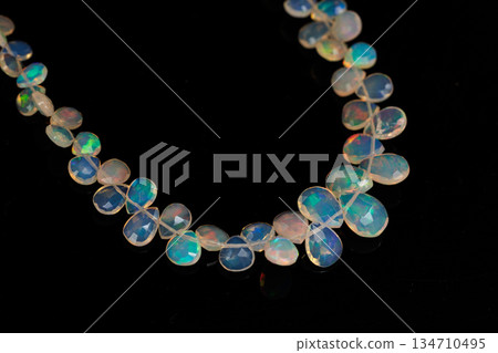Ethiopian Opal Drop Cut Play of Color Natural Stone Black Background Material Ethiopian Opal Drop Cut Play of Color Natural Stone Black Background Material 134710495