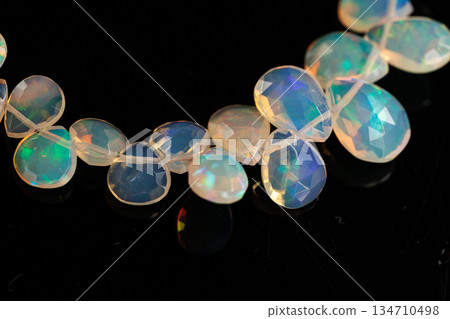 Ethiopian Opal Drop Cut Play of Color Natural Stone Black Background Material Ethiopian Opal Drop Cut Play of Color Natural Stone Black Background Material 134710498