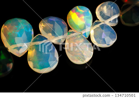 Ethiopian Opal Drop Cut Play of Color Natural Stone Black Background Material Ethiopian Opal Drop Cut Play of Color Natural Stone Black Background Material 134710501