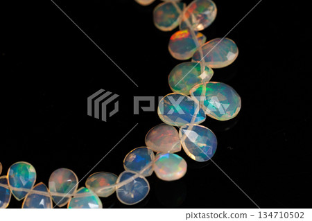 Ethiopian Opal Drop Cut Play of Color Natural Stone Black Background Material Ethiopian Opal Drop Cut Play of Color Natural Stone Black Background Material 134710502