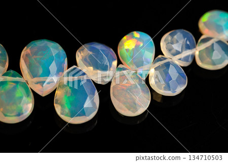 Ethiopian Opal Drop Cut Play of Color Natural Stone Black Background Material Ethiopian Opal Drop Cut Play of Color Natural Stone Black Background Material 134710503