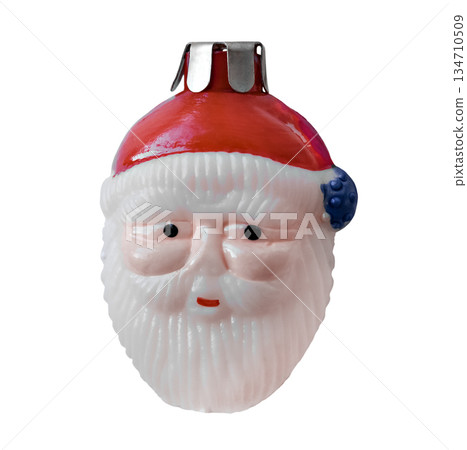 Christmas tree toy in the form of a smiling Santa Claus head. 134710509