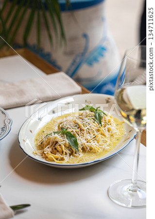 Creamy pasta with grated cheese and herbs 134711625