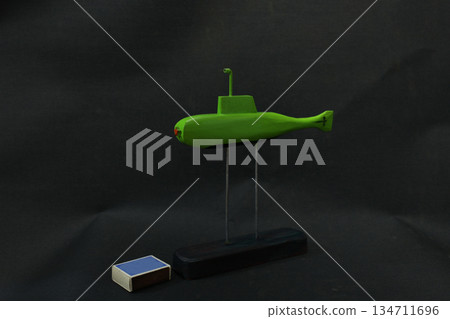 Green submarine and matchbox still life  134711696