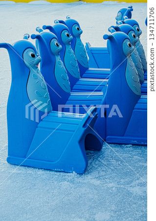 Ice Skating Support Chairs Standing on Rink Side View Ice Skating Support Chairs Standing on Rink Side View 134711706