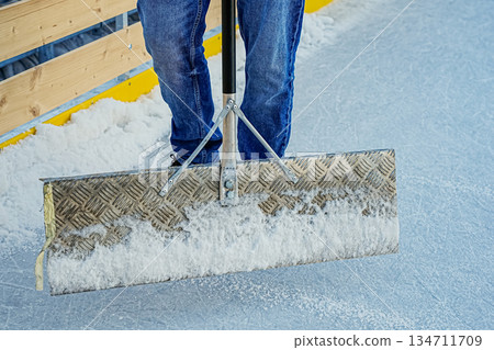 Close Up of Legs and Shovel Standing on Ice 134711709
