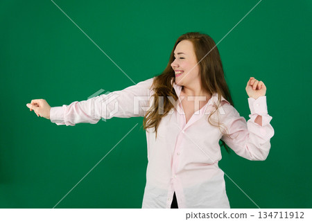 Advertisement concept. Portrait of gorgeous caucasian businesswoman showing two hands on copy space on grey background, presenting new product 134711912