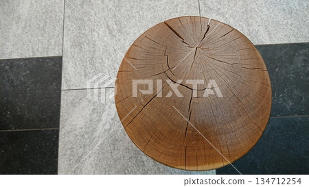 Top view of cracked wooden stump on stone floor 134712254
