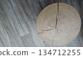 Top view of cracked wooden stump on textured floor 134712255
