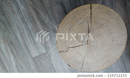 Top view of cracked wooden stump on textured floor Top view of cracked wooden stump on textured floor 134712255
