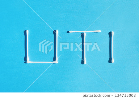 The word urinary tract infection UTI is lined with cotton sticks on a blue background The word urinary tract infection UTI is lined with cotton sticks on a blue background 134713008