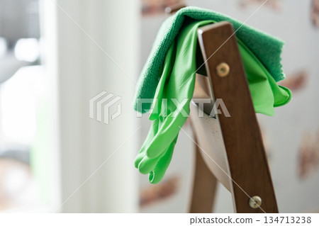 House cleaning products. Rubber protective gloves and colorful microfiber cleaning cloths. House cleaning concept House cleaning products. Rubber protective gloves and colorful microfiber cleaning cloths. House cleaning concept 134713238