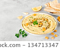 Vegan Lupin hummus with whole lupini beans, olive oil and pita bread, lemon and garlic on white background.  134713347