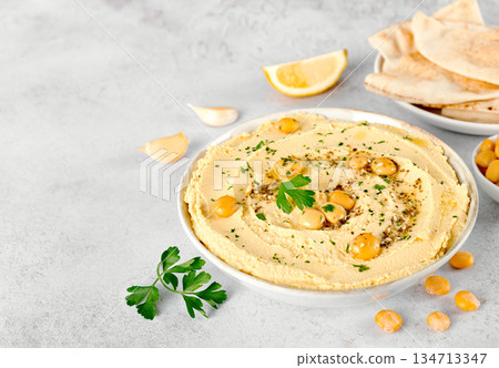 Vegan Lupin hummus with whole lupini beans, olive oil and pita bread, lemon and garlic on white background. Vegan Lupin hummus with whole lupini beans, olive oil and pita bread, lemon and garlic on white background. 134713347